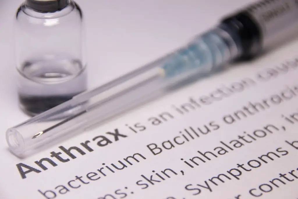 anthrax vaccine needle on paperwork