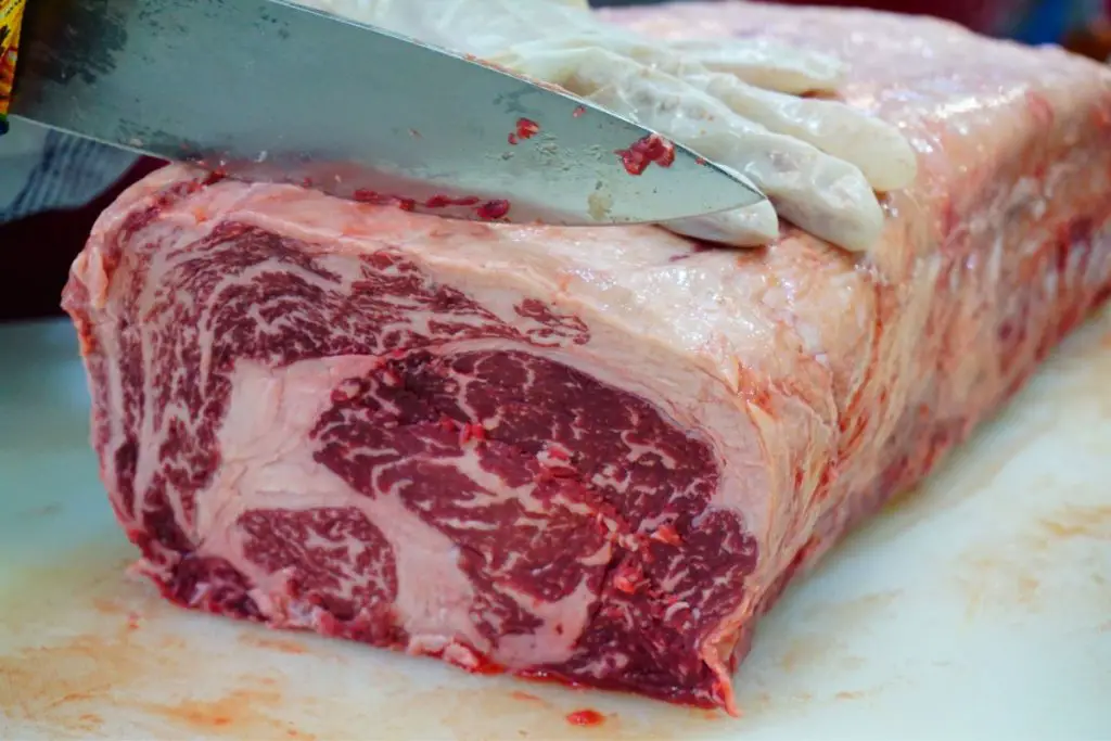 wagyu beef being sliced on table